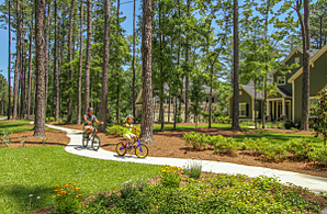 Residents bike along the sidewalk within WaterWays Township. 